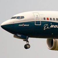 A Boeing 737 Max jet prepares to land.