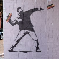 Banksy-style posters depicting a man throwing a sandwich in Washington, D.C.
