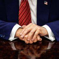 View of Donald Trump's hands on his desk in the Oval Office of the White House.
