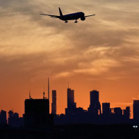 An airplane descends at O'Hare International Airport in Chicago, Wednesday, Nov. 12, 2025. 