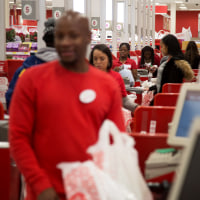 Employees ring customers up at cash registers inside a Target store in Jersey City, N.J.