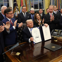 President Donald Trump signs funding legislation to reopen the federal government during a ceremony in the Oval Office of the White House on Thursday.
