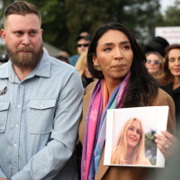 Sky Roberts, brother of Virginia Giuffre, who was abused by Jeffrey Epstein, stands with his wife Amanda Roberts, who holds a photo of Giuffre, during a news conference on the Epstein Files Transparency Act outside the U.S. Capitol on November 18, 2025.
