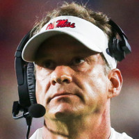 Lane Kiffin stands on the football field