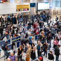 People wait in line at a security checkpoint at the George Bush Intercontinental Airport on November 06, 2025 in Houston, Texas. 
