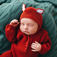 Cute baby boy sleeping on bed.
