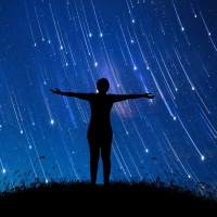 A girl standing in the midst of The stars at night with a meteor full of sky, concepts, imaginations, dreams