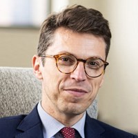 Nuno Loureiro sits on a couch