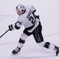 Nov 20, 2025; San Jose, California, USA; Los Angeles Kings center Phillip Danault (24) takes a shot on goal in overtime against the San Jose Sharks at SAP Center at San Jose. Mandatory Credit: David Gonzales-Imagn Images