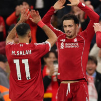 LIVERPOOL, ENGLAND - DECEMBER 13: Mohamed Salah of Liverpool celebrates with teammate Curtis Jones after Hugo Ekitike scored his team's second goal during the Premier League match between Liverpool and Brighton & Hove Albion at Anfield on December 13, 2025 in Liverpool, England. (Photo by Carl Recine/Getty Images)
