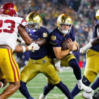 Notre Dame quarterback CJ Carr, center, runs with the ball in the second half of a NCAA football game against Southern California at Notre Dame Stadium on Saturday, Oct. 18, 2025, in South Bend.