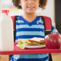 Student holding a school lunch tray