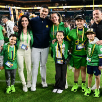 Head coach Marcus Freeman of the Notre Dame Fighting Irish poses with his family on the field following the 2025 Orange Bowl.