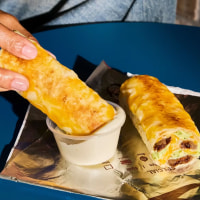 Taco Bell's Cheesy Dipping Burritos, now served with Creamy Garlic Sauce.