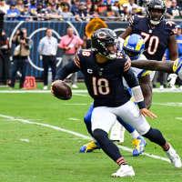 Sep 29, 2024; Chicago, Illinois, USA;  Los Angeles Rams linebacker Jared Verse (8) chases Chicago Bears quarterback Caleb Williams (18) during the first half at Soldier Field. Mandatory Credit: Matt Marton-Imagn Images
