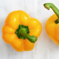 Studio shot of two yellow bell peppers
