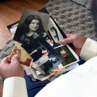 Derrick Johnson, whose mother's body was one of 189 left to decay in the Return to Nature Funeral Home in Penrose, Colo., holds photos of her in Colorado Springs, Colo., on Thursday, Feb. 5, 2026.