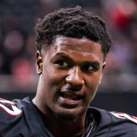 James Pearce Jr speaks to an interviewer on the football field