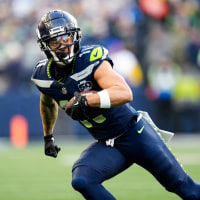 Jaxon Smith-Njigba runs with the football on the field