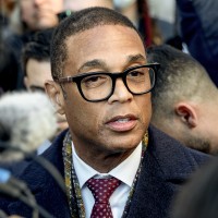 Don Lemon is surrounded by cameras and reporters. 