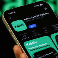 Kalshi App Page Shown On Smartphone With Kalshi Branding In Background