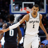 Feb 23, 2026; Detroit, Michigan, USA;  San Antonio Spurs forward Victor Wembanyama (1) receives congratulations from guard Devin Vassell (24) in the second half against the Detroit Pistons at Little Caesars Arena. Mandatory Credit: Rick Osentoski-Imagn Images