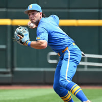 Jun 14, 2025; Omaha, Neb, USA;  UCLA Bruins shortstop Roch Cholowsky (1) completes a double play against the Murray State Racers during the second inning at Charles Schwab Field. Mandatory Credit: Steven Branscombe-Imagn Images