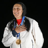 Elana Meyers Taylor with her gold medal at the Milan Olympics.  
