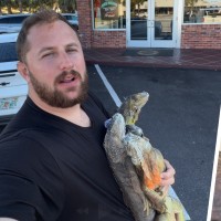 Ryan Izquierda and two frozen iguanas he foraged, which he gave to Bucks Coal Fired Pizza to turn into the final pie, shown right.