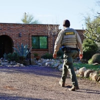 A member of the Pima County sheriff's office walks outside of Nancy Guthrie's home on Feb. 9, 2026 in Tucson, Ariz. 