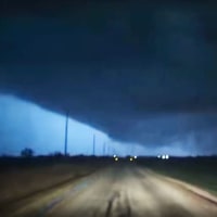 A large funnel cloud illuminated by lightning in Fairview, Okla., on Thursday.