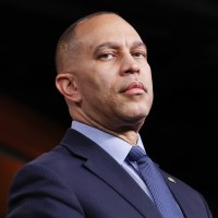 Hakeem Jeffries looks downward into the camera. 