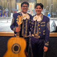 Antonio, third from left, and Caleb Gámez-Cuéllar, hold a trophy surrounded by their brother, mother and father.