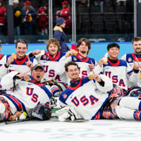 Team United States celebrates on the ice