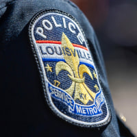 A Louisville police department patch is seen on the shoulder of an officer's shirt