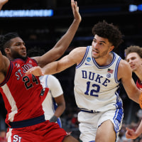 Duke star Cameron Boozer drives around Zuby Ejiofor of St. John's during the second half in the Sweet Sixteen.