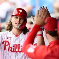 Alec Bohmof the Philadelphia Phillies celebrates with teammates in the dugout after hitting a home run in the third inning against the Toronto Blue Jays during a Grapefruit League spring training game at BayCare Ballpark. 