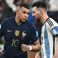 France's forward #10 Kylian Mbappe (L) gestures towards Argentina's forward #10 Lionel Messi (R) during the Qatar 2022 World Cup final football match between Argentina and France at Lusail Stadium in Lusail, north of Doha on December 18, 2022. (Photo by Anne-Christine POUJOULAT / AFP) (Photo by ANNE-CHRISTINE POUJOULAT/AFP via Getty Images)