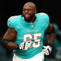 MIAMI GARDENS, FLORIDA - DECEMBER 22: Robert Jones #65 of the Miami Dolphins runs onto the field prior to an NFL football game against the San Francisco 49ers at Hard Rock Stadium on December 22, 2024 in Miami Gardens, Florida. (Photo by Kevin Sabitus/Getty Images)