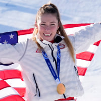 Feb 18, 2026; Cortina d'Ampezzo, Italy; Gold medalist Mikaela Shiffrin of the United States celebrates during the medal ceremony for the women's slalom during the Milano Cortina 2026 Olympic Winter Games at Tofane Alpine Skiing Centre. Mandatory Credit: Michael Madrid-Imagn Images