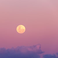 Beautiful pink and purple full moon rise at sunset