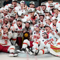 Denver players celebrate after defeating Wisconsin in the championship game at the NCAA Frozen Four men's college hockey tournament on Saturday.