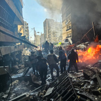 First responders stand amid rubble at the site of an Israeli airstrike in Beirut's Corniche al-Mazraa neighborhood on April 8, 2026. 