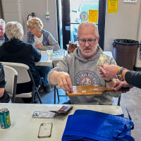 People buy tickets for the raffle.