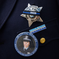 An officer wears a button showing slain Chicago police Officer Krystal Rivera.