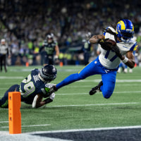 Davante Adams of the Los Angeles Rams dives with a ball against Josh Jobe of the Seattle Seahawks