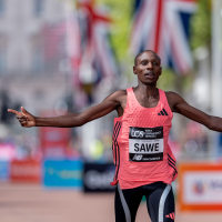 Sabastian Sawe celebrates as he crosses the finish line to win the London Marathon and break the Marathon World Record on Sunday, April 26.