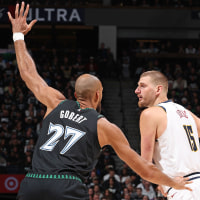 Nikola Jokic of the Denver Nuggets is guarded by Rudy Gobert of the Minnesota Timberwolves 