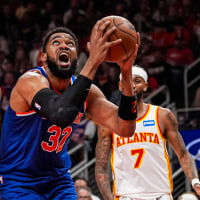 Apr 25, 2026; Atlanta, Georgia, USA; New York Knicks center Karl-Anthony Towns (32) tries to reach the basket against Atlanta Hawks forward Onyeka Okongwu (17) during the first half at State Farm Arena. Mandatory Credit: Dale Zanine-Imagn Images
