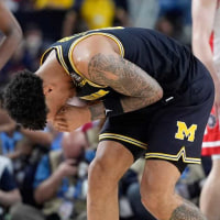 Michigan forward Yaxel Lendeborg (23) reacts in pain after being fouled by Arizona forward Koa Peat (10) in the first half of their Final Four game at Lucas Oil Stadium in Indianapolis on Saturday, April 4, 2026.